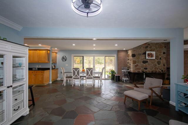 dining space with crown molding and ceiling fan