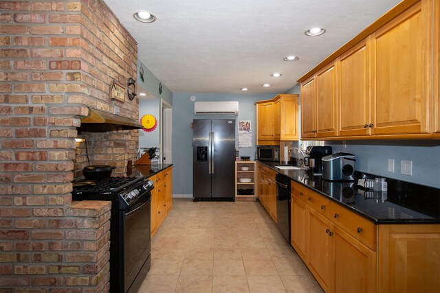 kitchen with black appliances, sink, a wall mounted air conditioner, dark stone counters, and light tile patterned floors