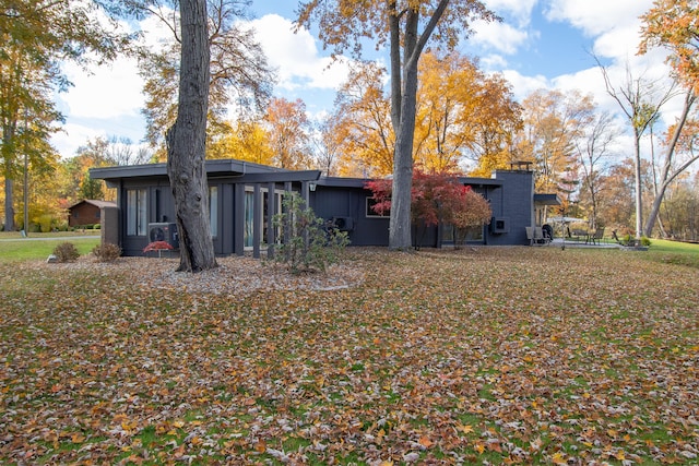 rear view of property with a yard