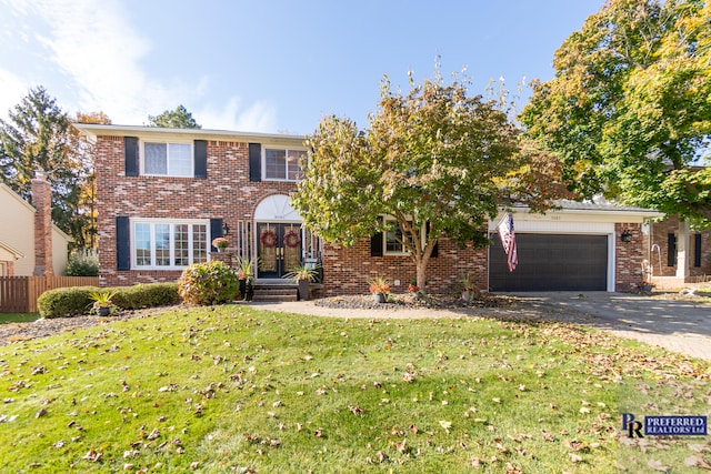 view of front of house with a garage and a front lawn