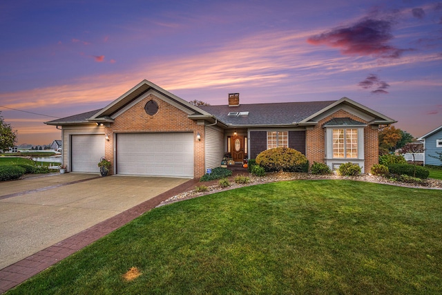 ranch-style house with a garage and a lawn