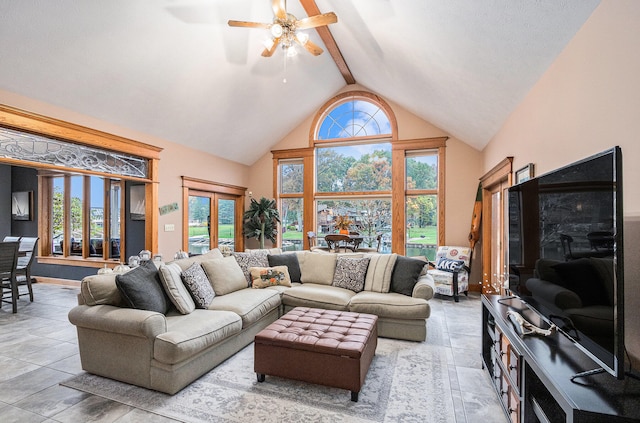 living room featuring ceiling fan, high vaulted ceiling, and beamed ceiling