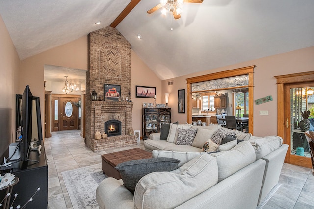 tiled living room featuring ceiling fan with notable chandelier, beamed ceiling, high vaulted ceiling, and a fireplace