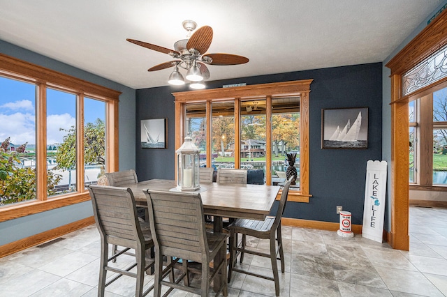 dining room with ceiling fan and light tile patterned flooring