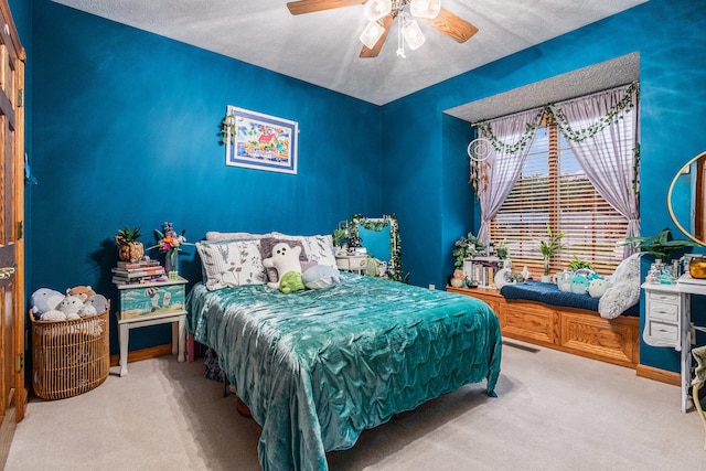 carpeted bedroom featuring a textured ceiling and ceiling fan