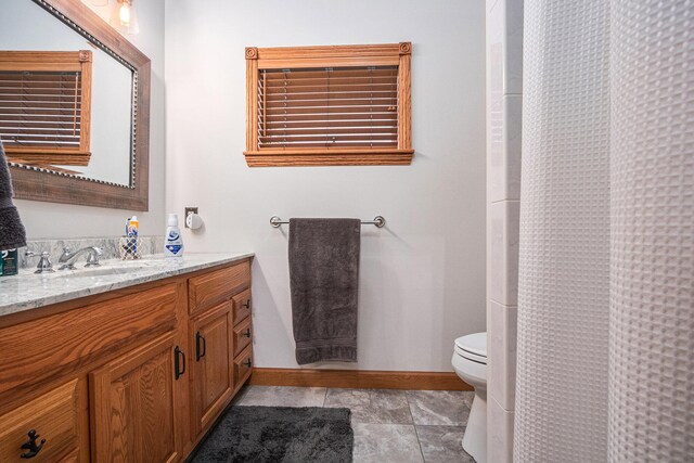 bathroom with vanity, toilet, and tile patterned flooring