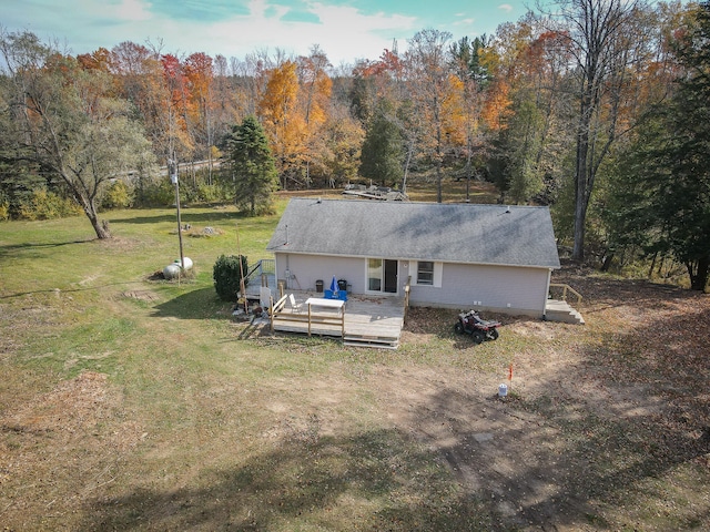 rear view of house featuring a yard and a wooden deck