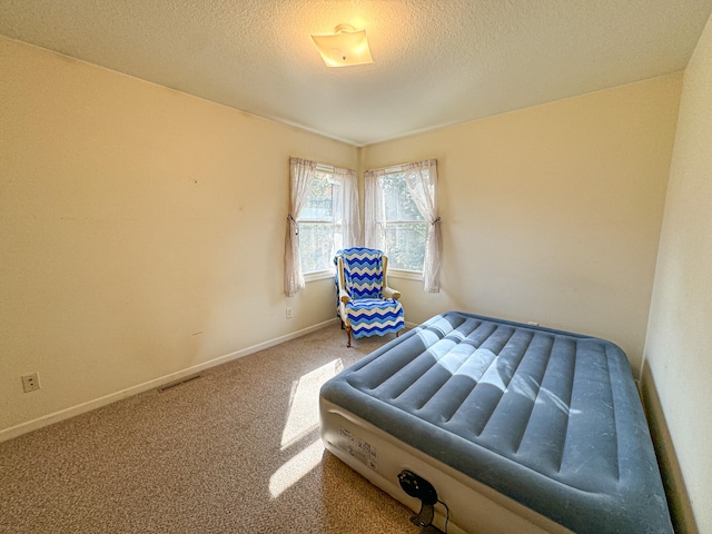 carpeted bedroom with a textured ceiling