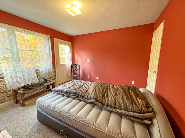 bedroom with a textured ceiling and carpet