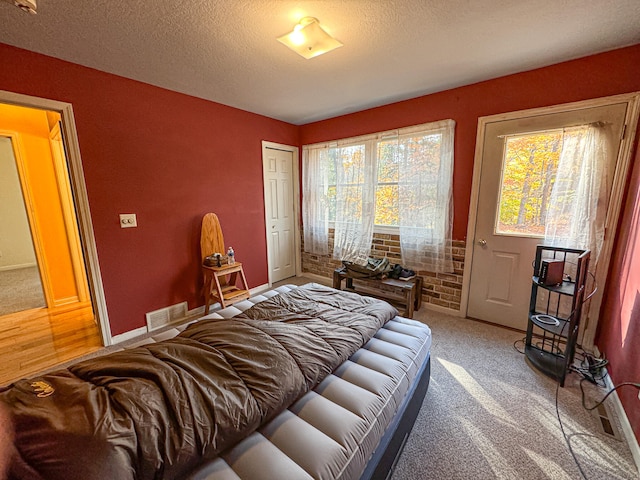 carpeted bedroom with a textured ceiling