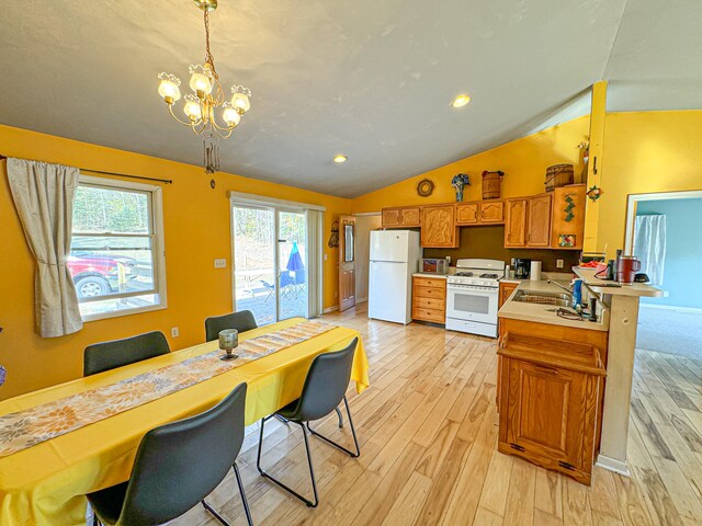 kitchen with white appliances, kitchen peninsula, lofted ceiling, decorative light fixtures, and a breakfast bar