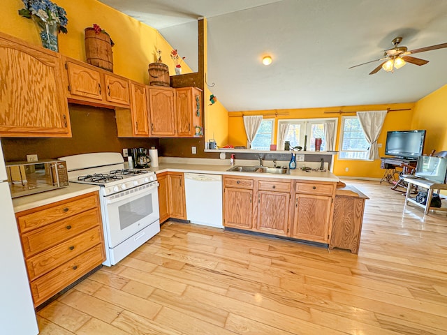 kitchen featuring white appliances, light hardwood / wood-style floors, sink, and ceiling fan