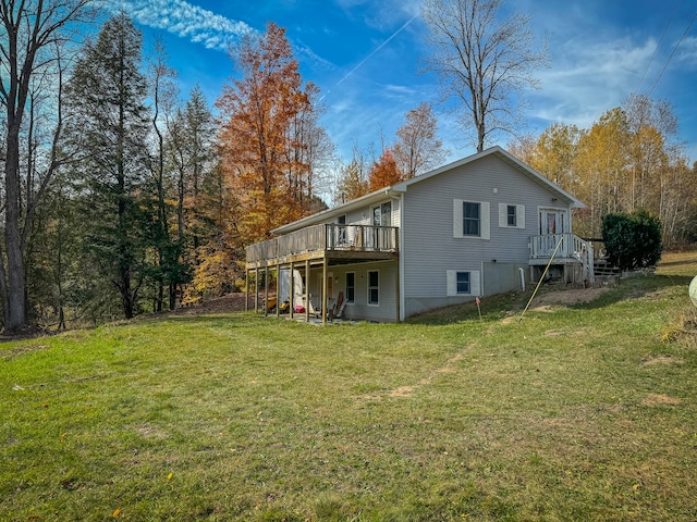 back of house featuring a deck and a lawn