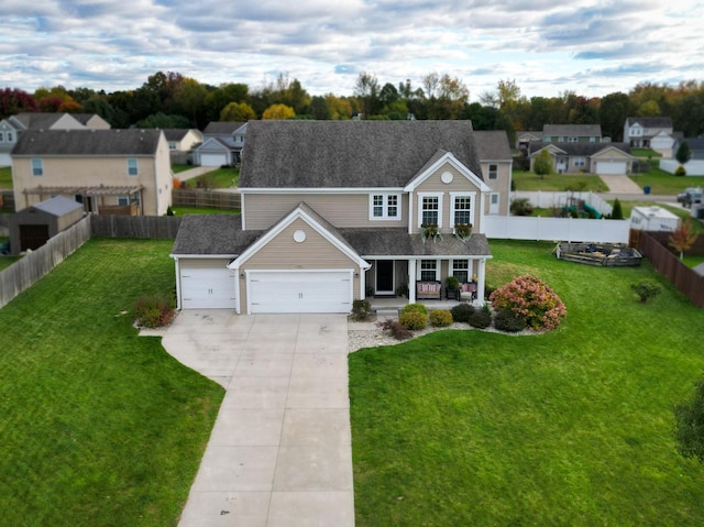 view of front of home featuring a front yard, a porch, and a garage