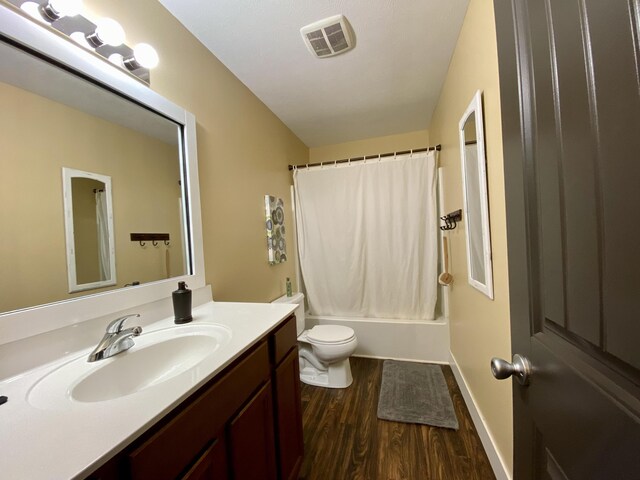 full bathroom with vanity, toilet, shower / tub combo, and hardwood / wood-style floors