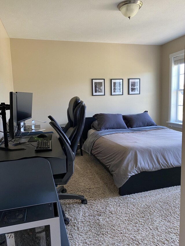 bedroom featuring a textured ceiling and carpet floors