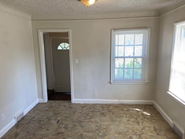 spare room featuring a textured ceiling