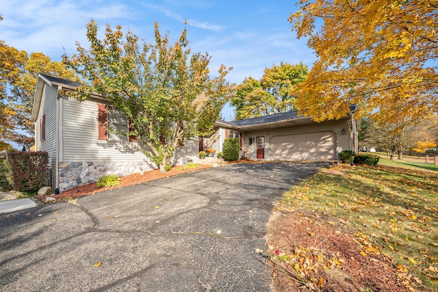 ranch-style house with a front yard and a garage