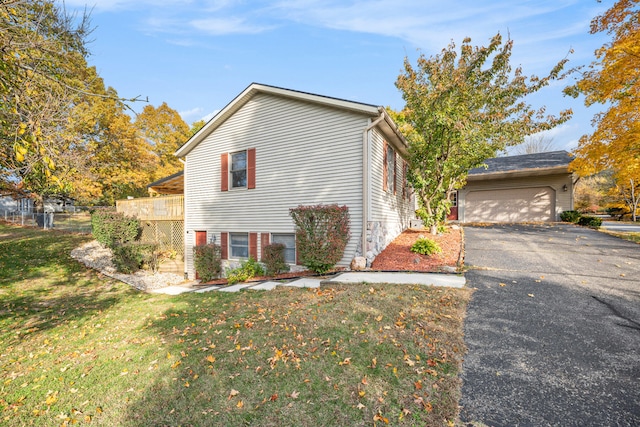 view of front of property featuring a garage and a front lawn