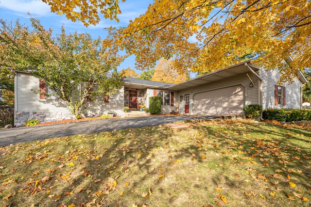 ranch-style home with a front yard and a garage