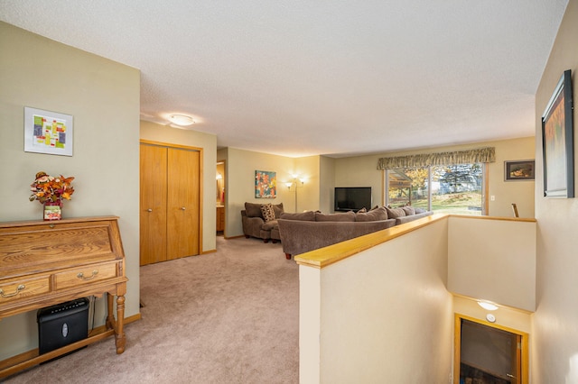 living room with light carpet and a textured ceiling