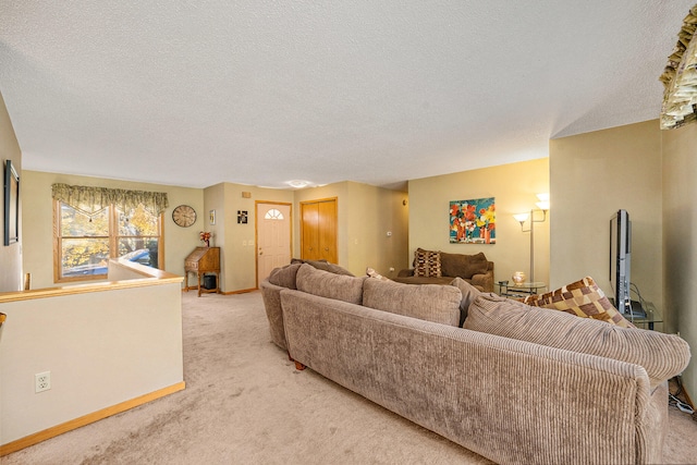 living room with a textured ceiling and light colored carpet