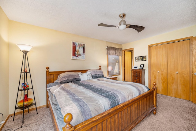 carpeted bedroom with a textured ceiling, a closet, and ceiling fan