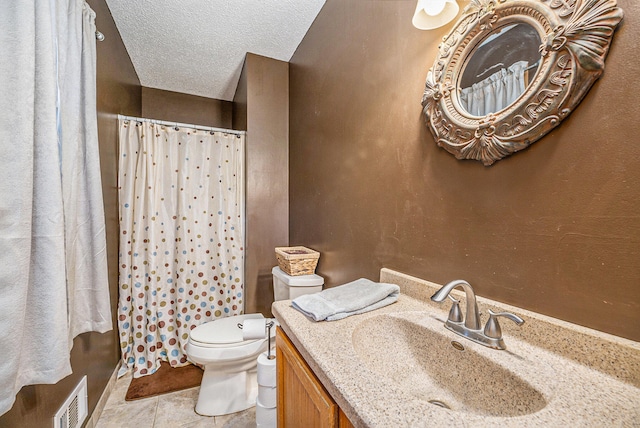 bathroom featuring toilet, tile patterned flooring, a shower with shower curtain, vanity, and a textured ceiling