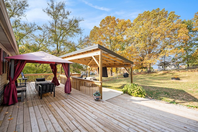 wooden terrace featuring a gazebo and a yard