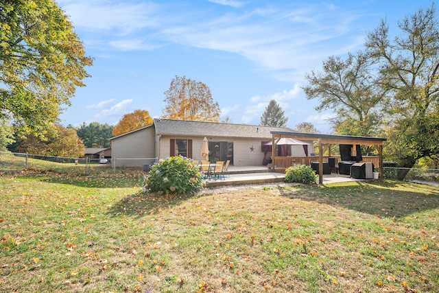 rear view of house with a patio area, a gazebo, and a lawn