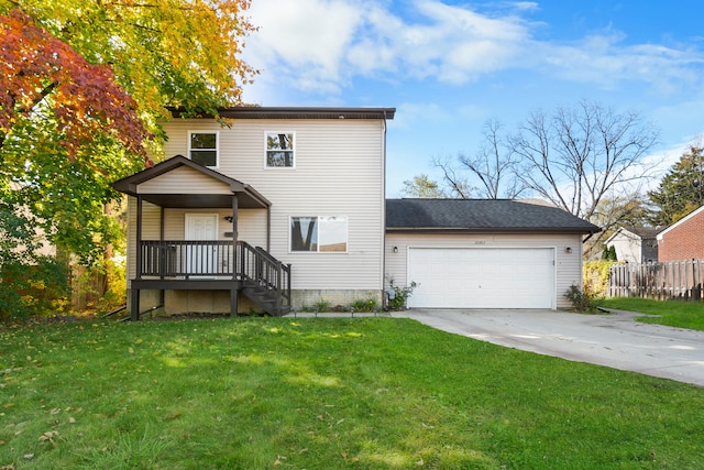 rear view of property featuring a yard, a porch, and a garage