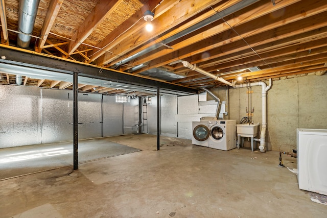 basement with washing machine and dryer and sink