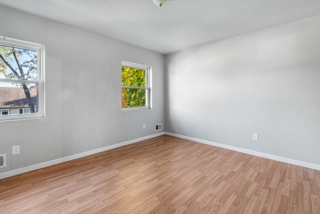 unfurnished room with light hardwood / wood-style floors