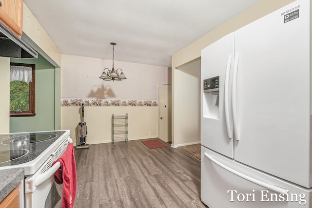 kitchen featuring white appliances, light wood-type flooring, decorative light fixtures, a notable chandelier, and exhaust hood