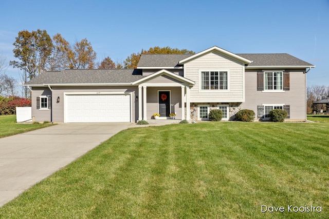 view of front of property with a garage and a front yard