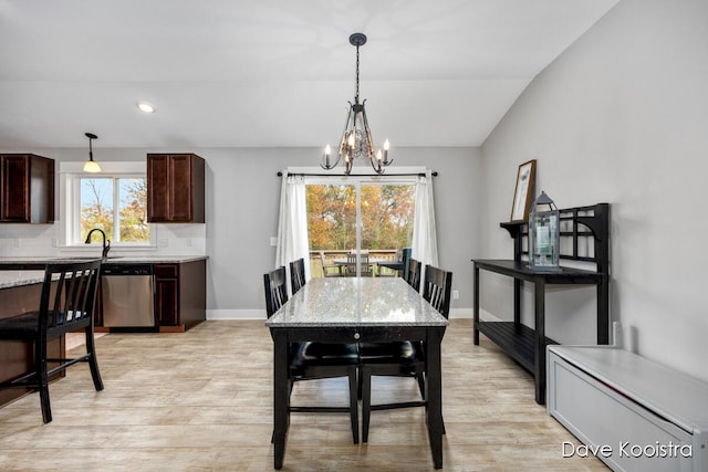 dining space featuring a chandelier, a healthy amount of sunlight, and light hardwood / wood-style flooring