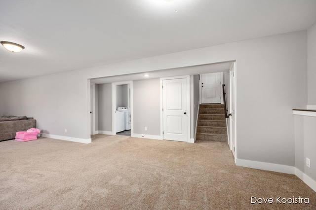 basement with separate washer and dryer and light carpet