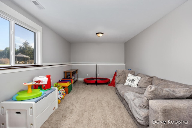 recreation room featuring light carpet