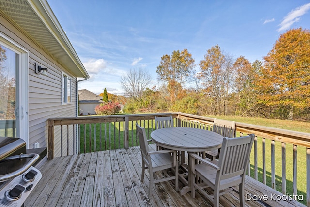 wooden terrace with grilling area and a yard