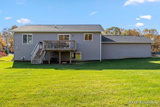 rear view of house featuring a wooden deck and a yard