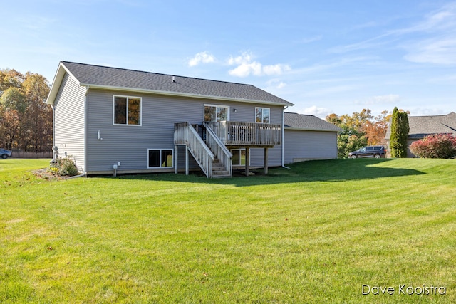 back of house featuring a yard and a wooden deck