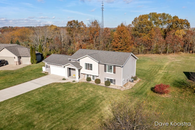 view of front of house with a garage and a front lawn