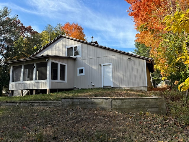 back of house with a sunroom