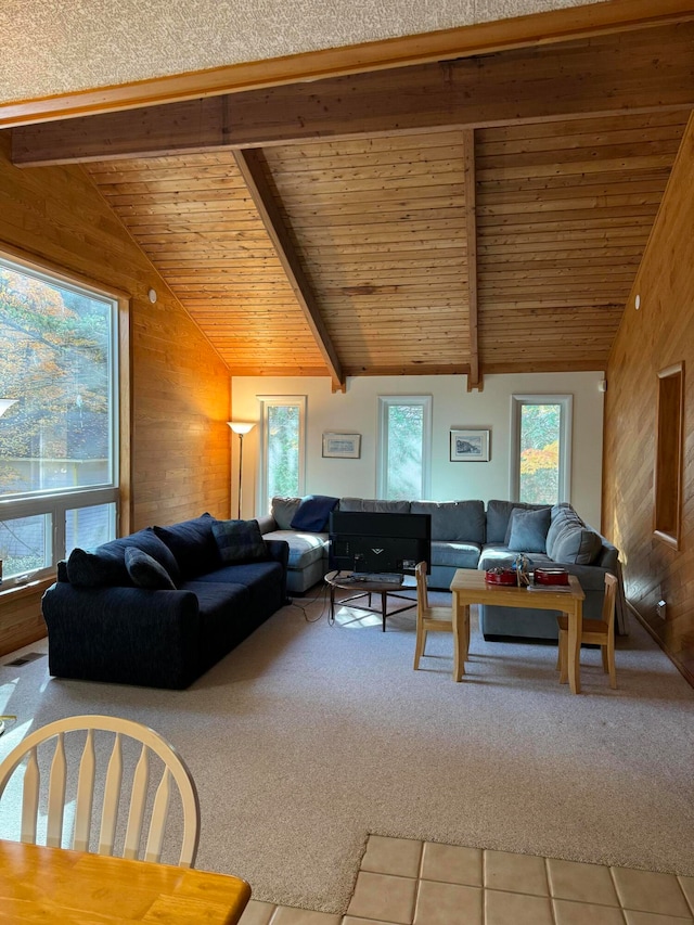 carpeted living room featuring lofted ceiling with beams, wooden ceiling, and wood walls