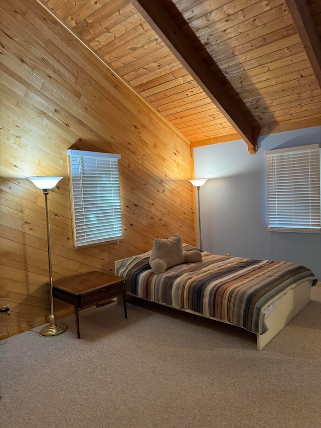 carpeted bedroom with beamed ceiling, wooden ceiling, and wooden walls