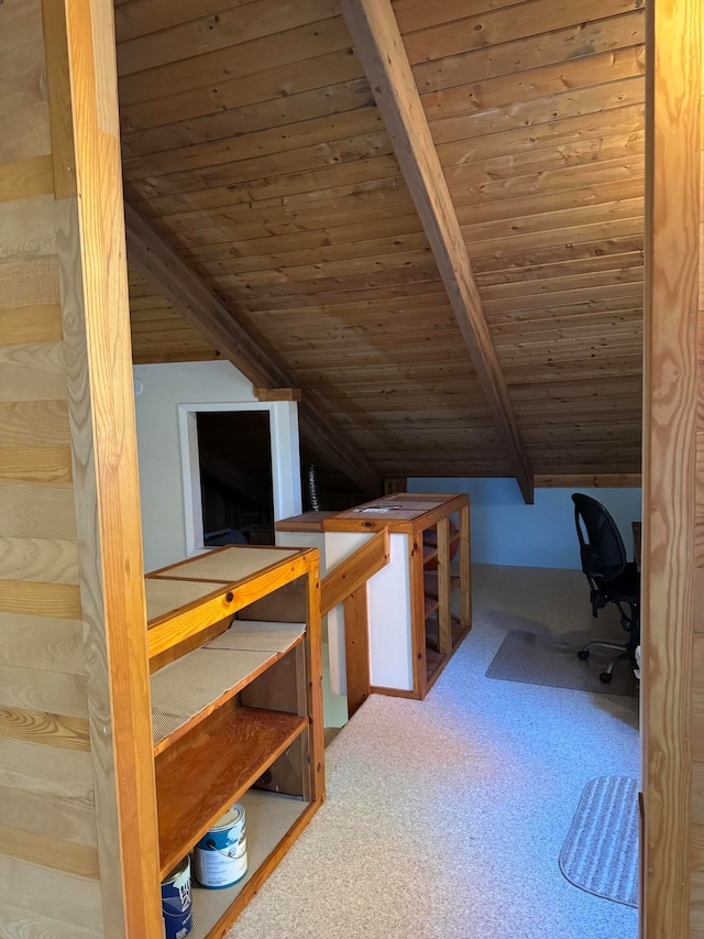 unfurnished office featuring lofted ceiling with beams, wooden ceiling, and carpet floors