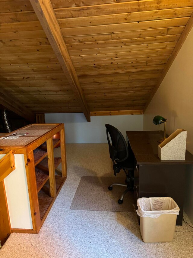 unfurnished office featuring vaulted ceiling with beams, wood ceiling, and carpet floors