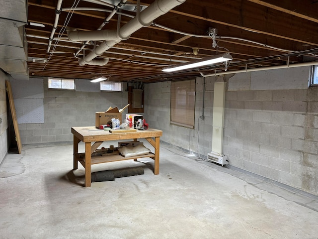 basement with a workshop area and electric panel