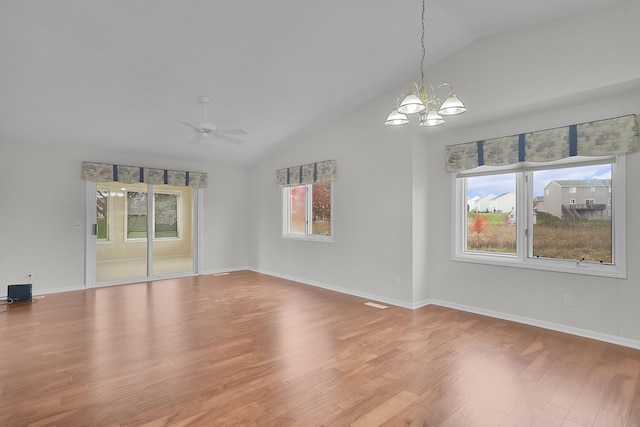 unfurnished room featuring hardwood / wood-style flooring, lofted ceiling, and plenty of natural light