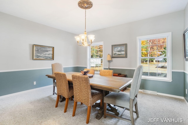 dining space with a chandelier